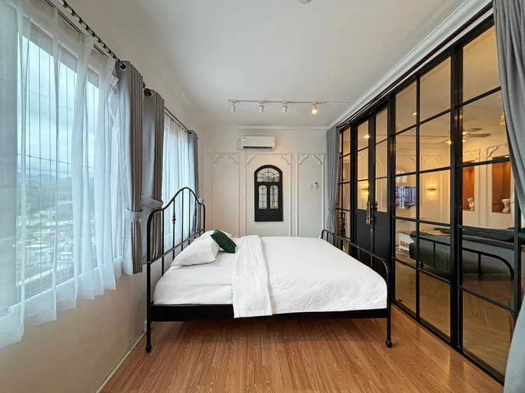 Paris: A black-framed glass partition separates the bedroom from the living room.