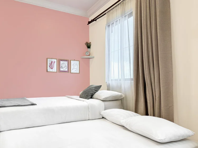 Milan: The sliding bed pulled out into two beds side by side; white sheets, as in all our units.