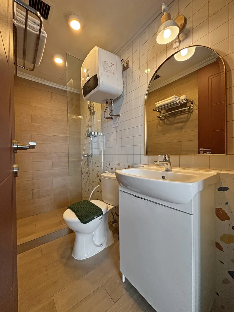 Busan: Bathroom with a water heater; soap and shampoo the same in every unit.