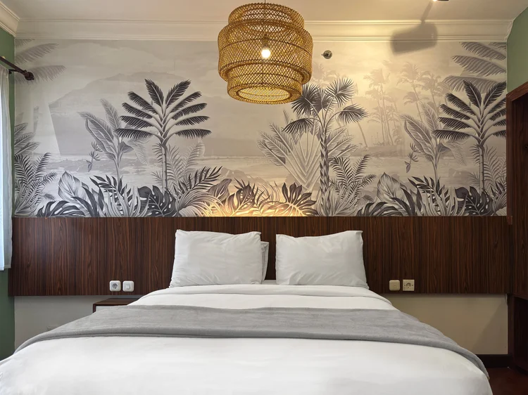 Panama: Tropical leaf wallpaper above the headboard, true to the Lush Utopian theme.