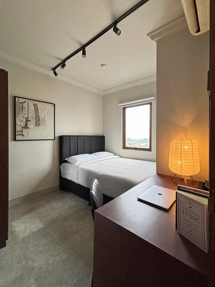 Saitama: A bedroom corner with a desk and warm lamp, somewhere to set things down before bed.