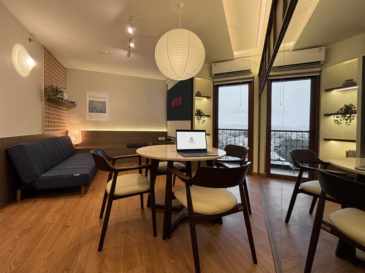 Aoyama: Living and dining area with AC, a paper lantern and a corner desk for work.