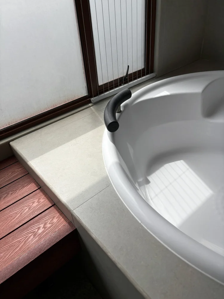 Okinawa: The private indoor onsen has a wood-decked edge, an Okinawa signature detail.