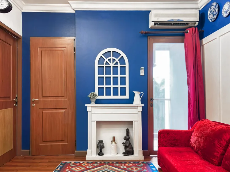 Amsterdam: A decorative fireplace and the door to the small balcony, with AC in the living room.