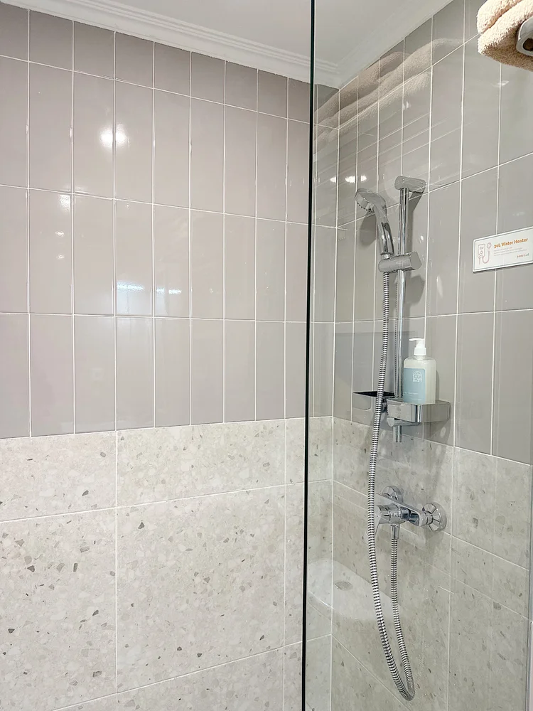 Jeju: A bathroom with a hot water shower, ready any time.