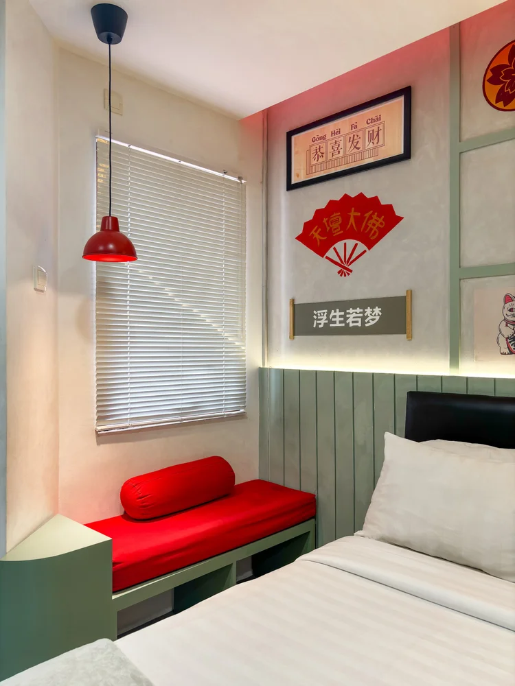 Hong Kong: The pull-out bed by the window, with a small red bench beside it.