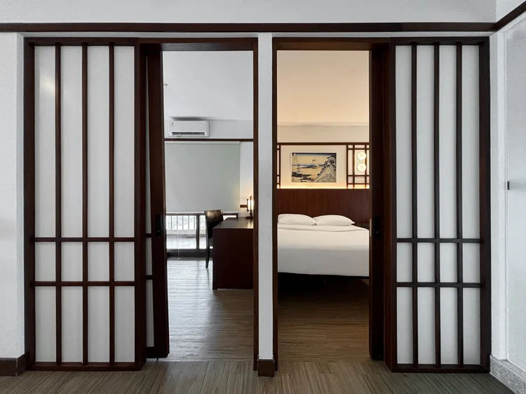 Okinawa: Shoji-style sliding doors connect two bedrooms, a Japanese design touch.