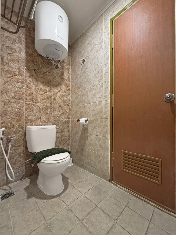 Honolulu: Bathroom with a water heater, one of two in this unit.