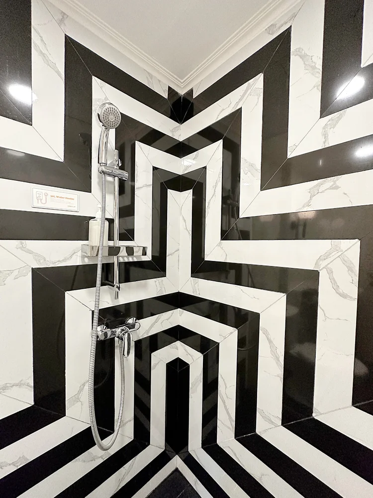 New York: A hot shower with striped black-and-white tiles.
