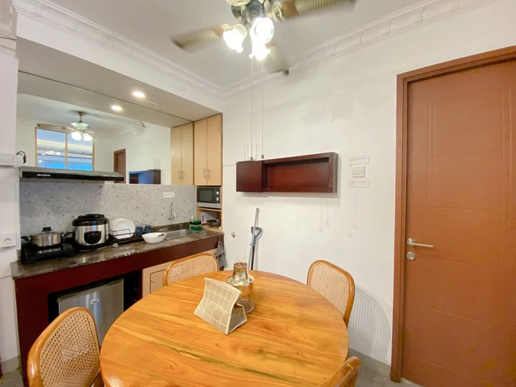 Budapest: Round wooden dining table for four, right beside the kitchen.